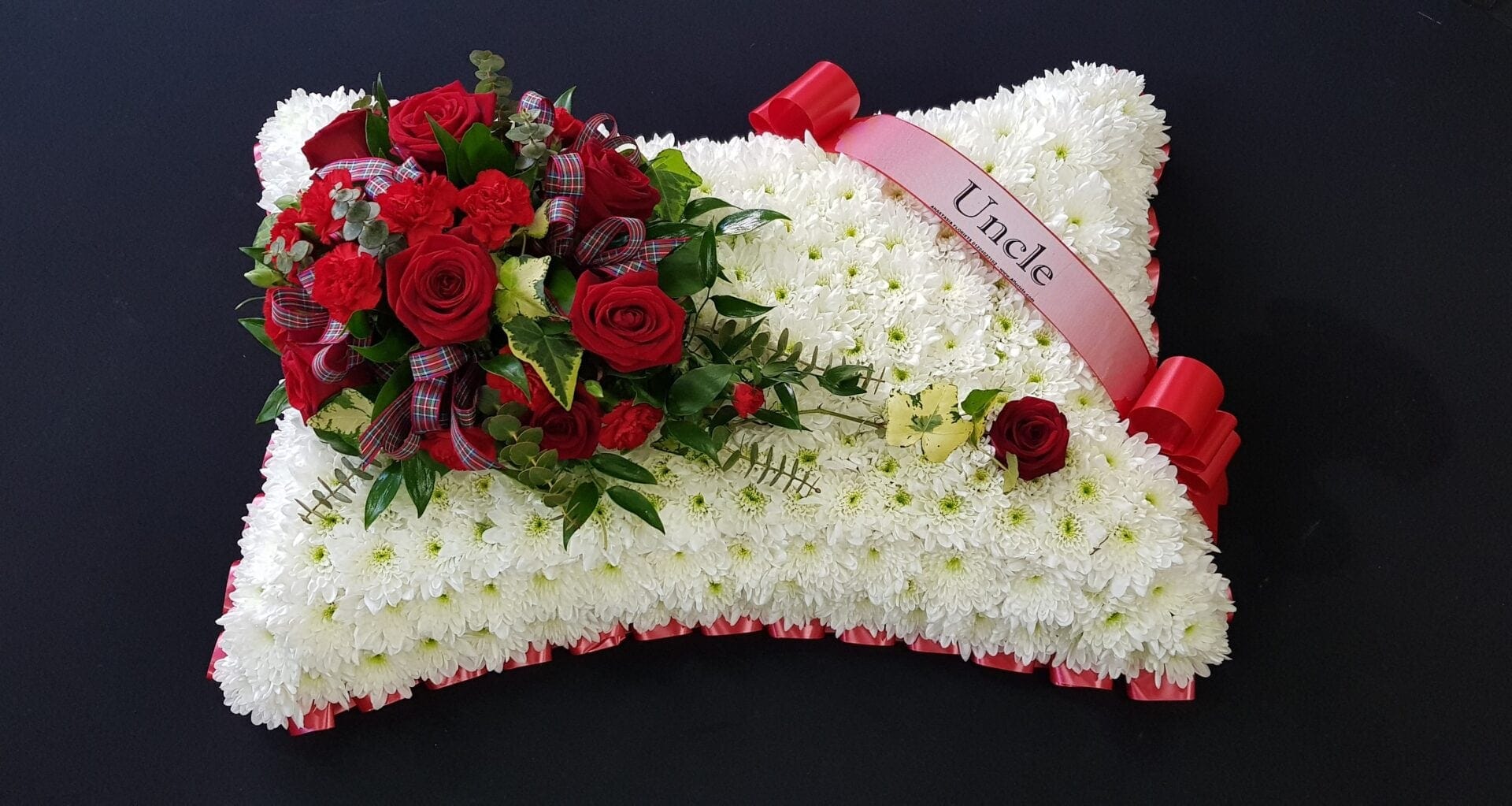Uncle red rose funeral pillow tribute with white chrysanthemum base and red ribbon edge