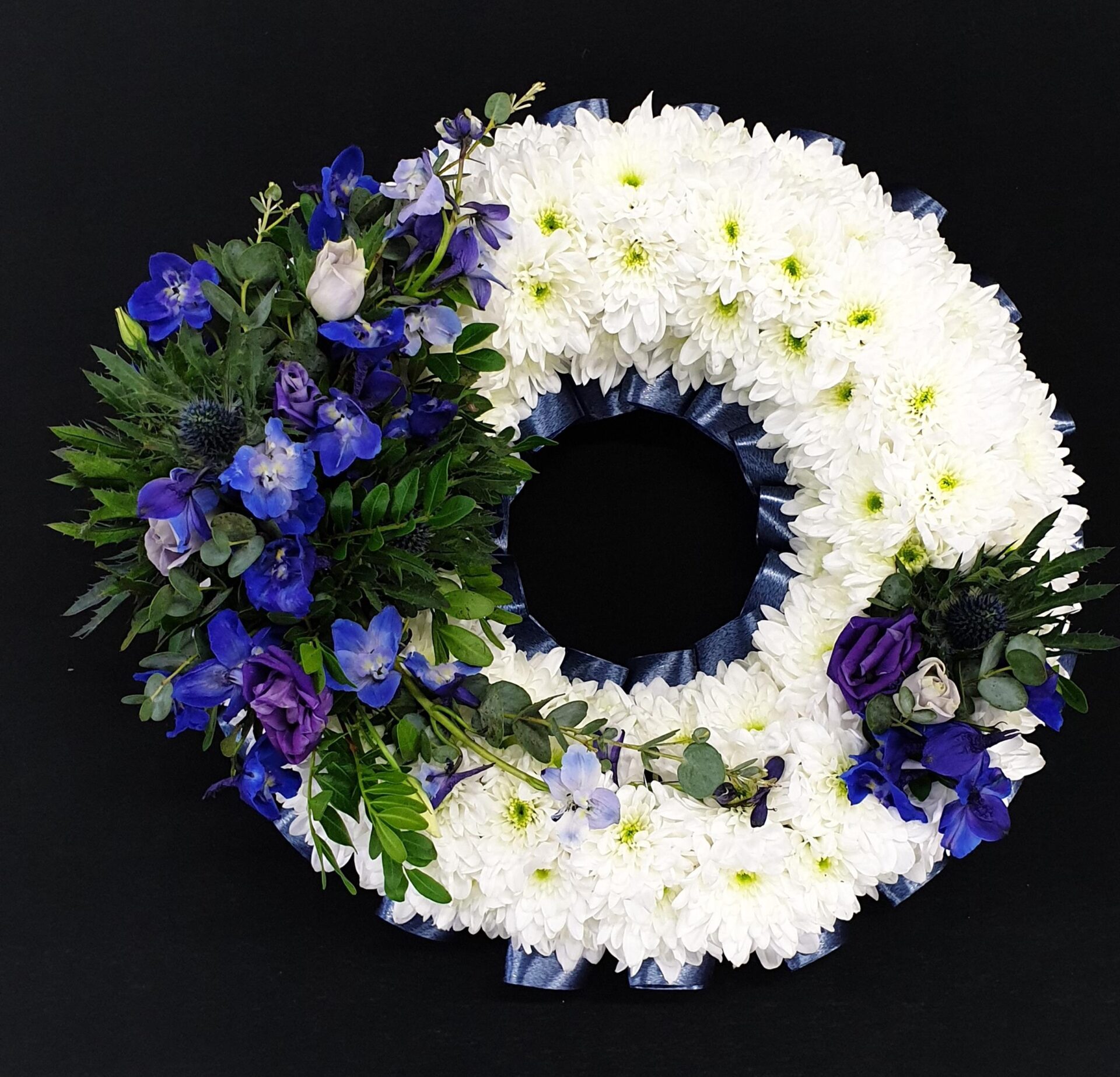White and blue funeral flower wreath