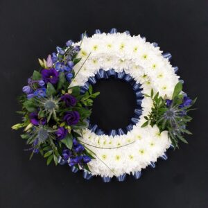 White chrysanthemum and blue lisianthus funeral wreath