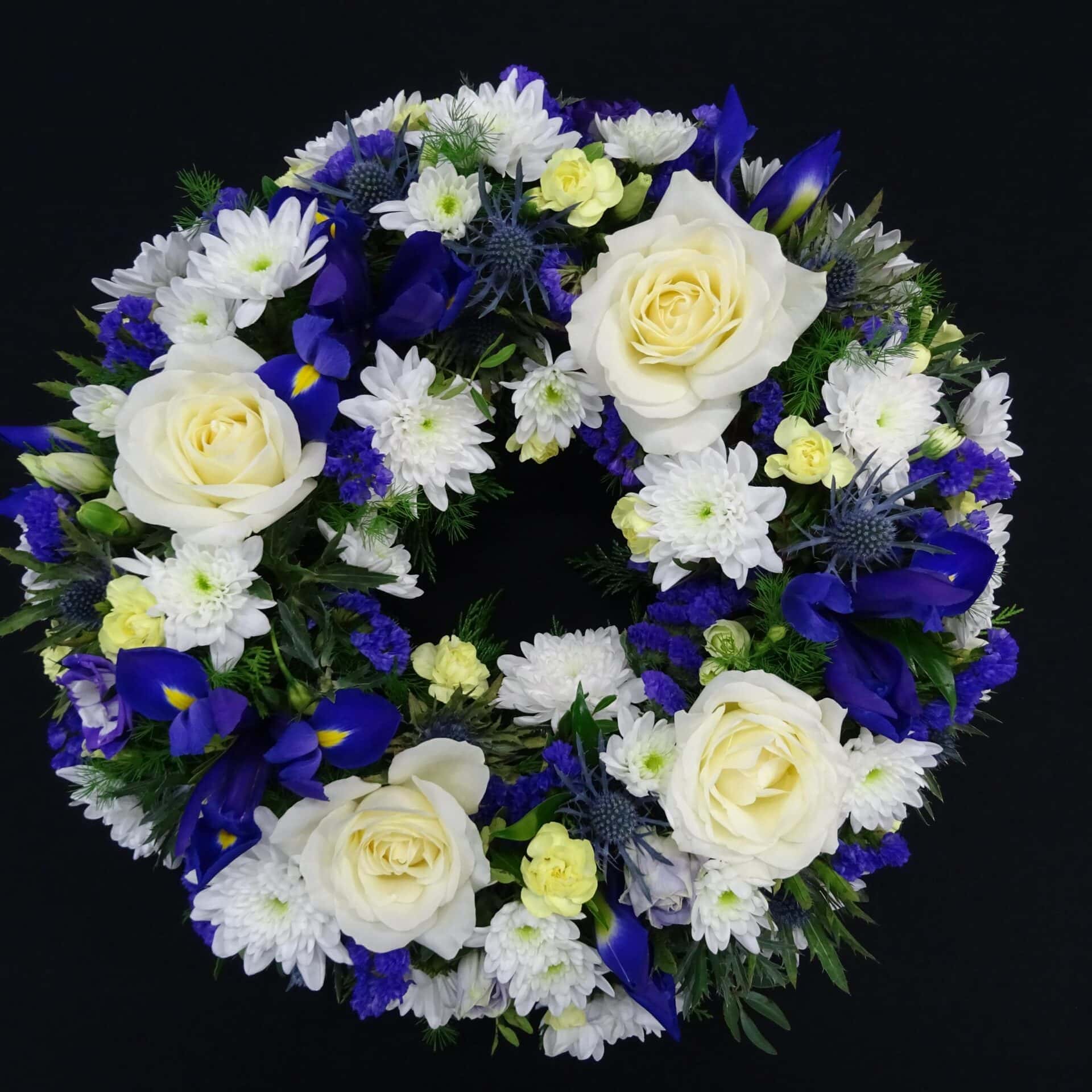 White and blue funeral wreath with roses