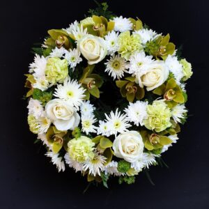 White and green funeral wreath with roses, orchids, carnations and chrysanthemums