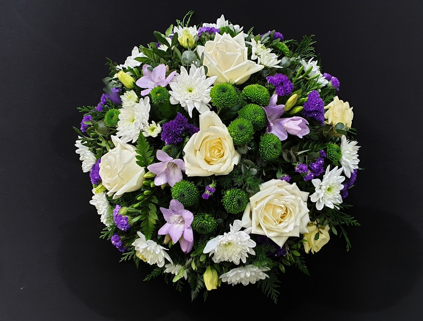 Funeral posy with white roses and chrysanthemums