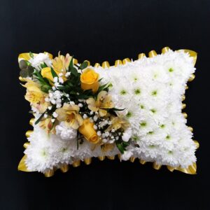 Yellow rose funeral pillow tribute with white chrysanthemum base and yellow ribbon edge