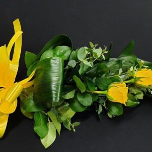 Simple yellow rose funeral sheaf with greenery and yellow bow