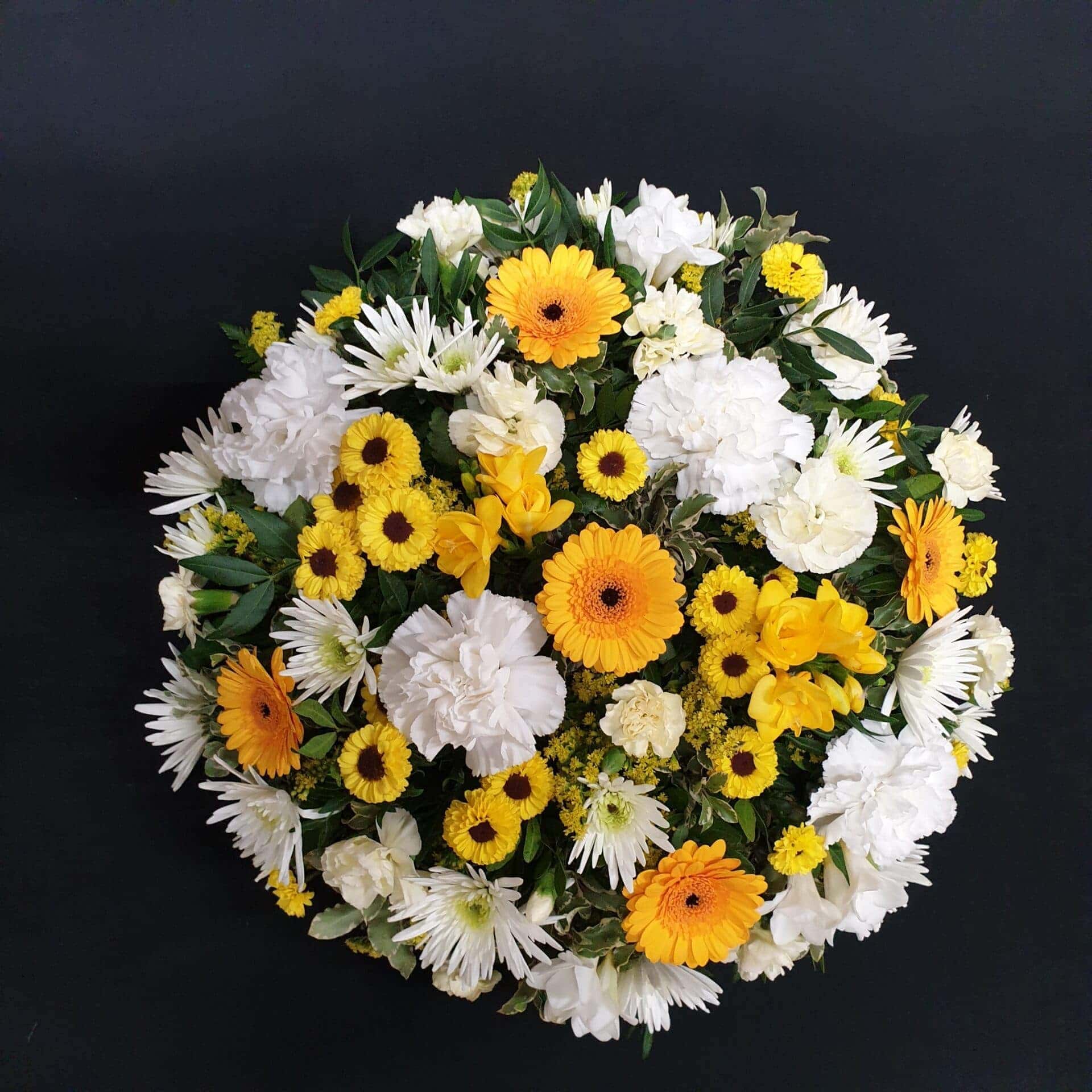 Yellow and white funeral posy with gerberas, carnations and chrysanthemums